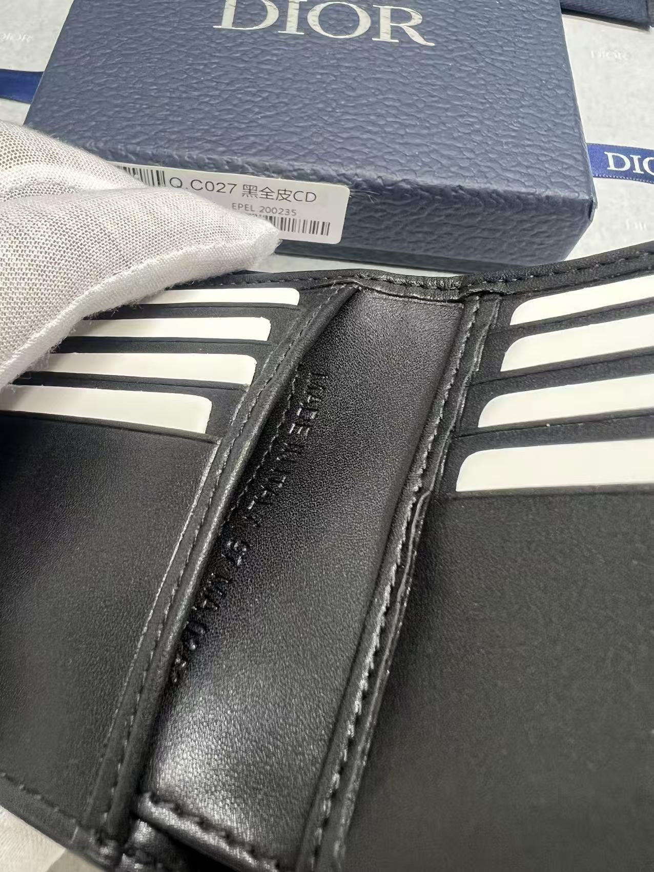 Small leather wallet, close-up of stitched edges and interior card slots