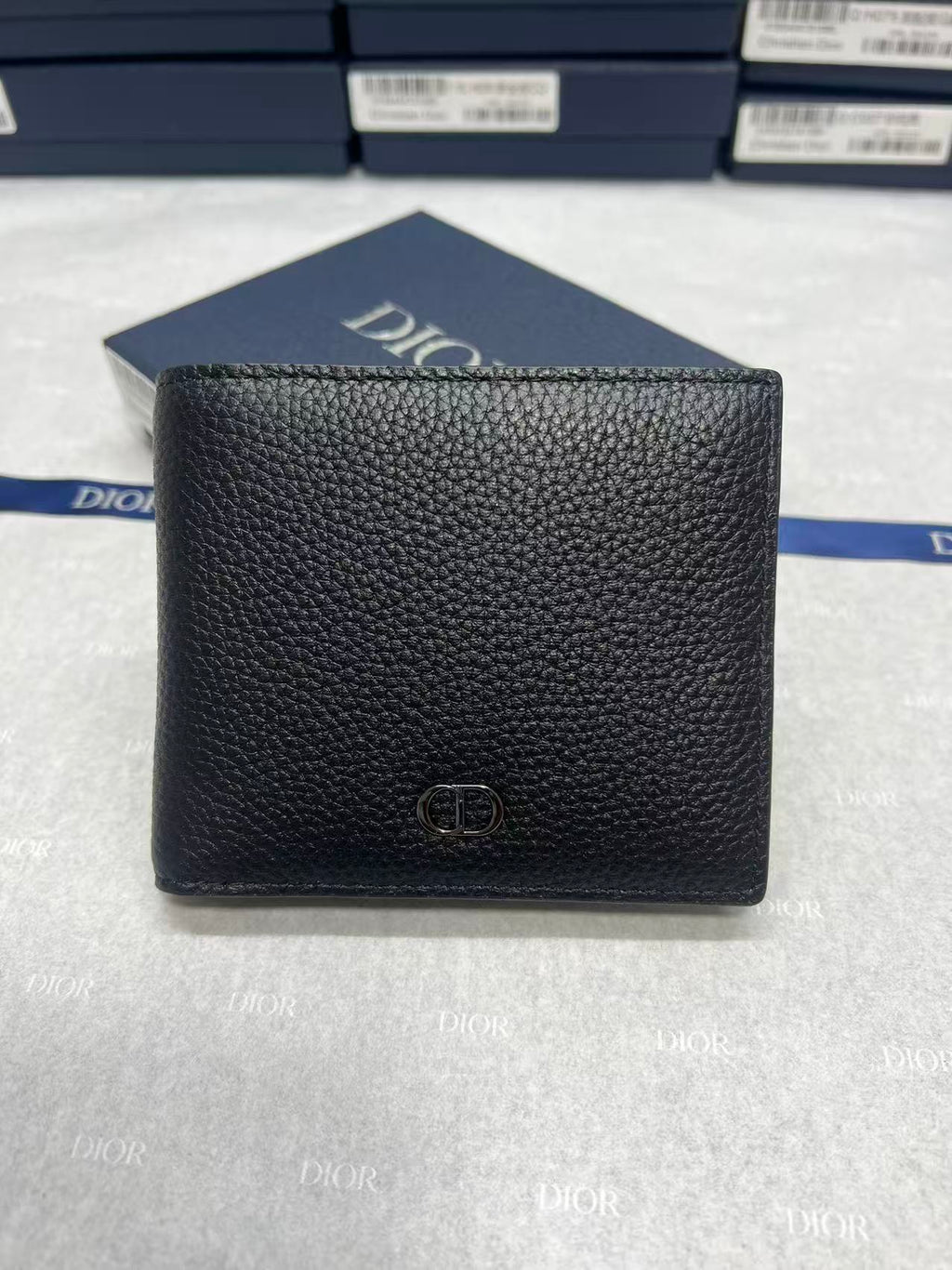 Small leather wallet, black textured finish with Dior emblem on the front