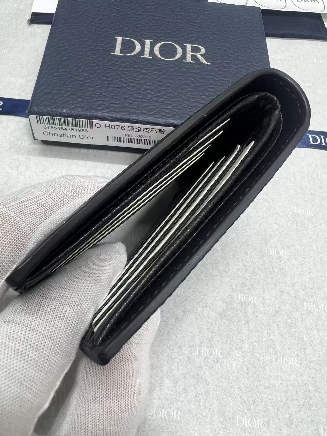 Black leather small wallet with accordion-style interior compartments and Dior logo