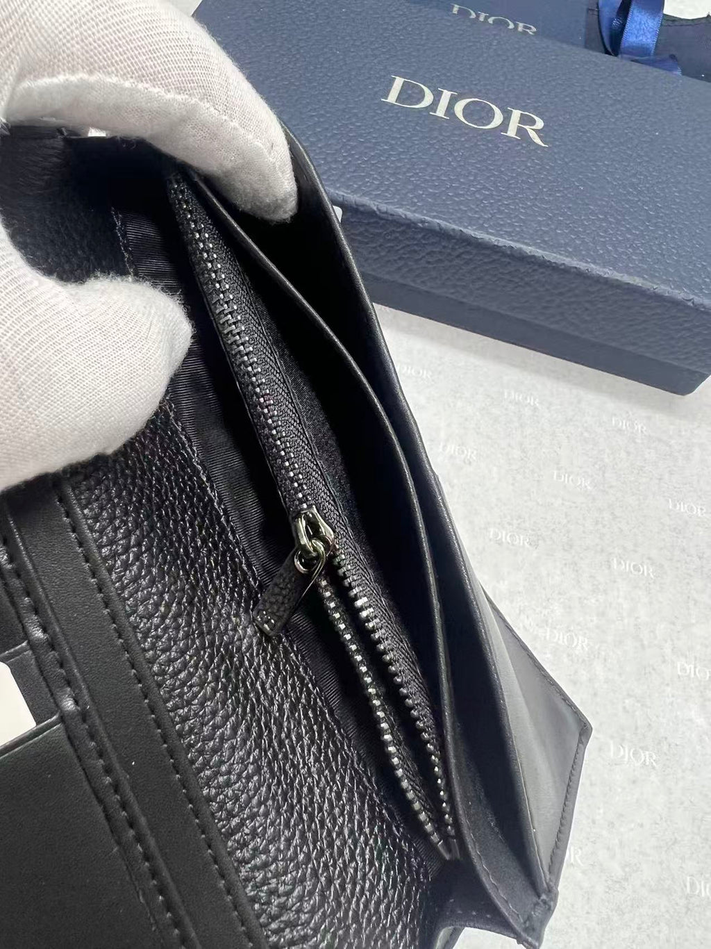 Dior small bag close-up, side zipper pocket on textured leather