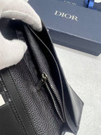 Dior small bag close-up of textured black leather and silver zipper pull