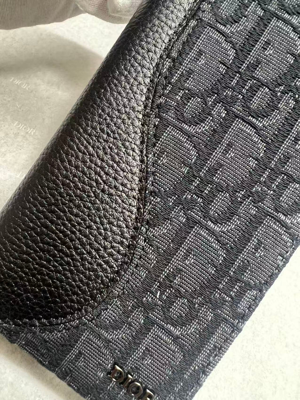 Dior small bag close-up, monogram fabric panel with leather trim