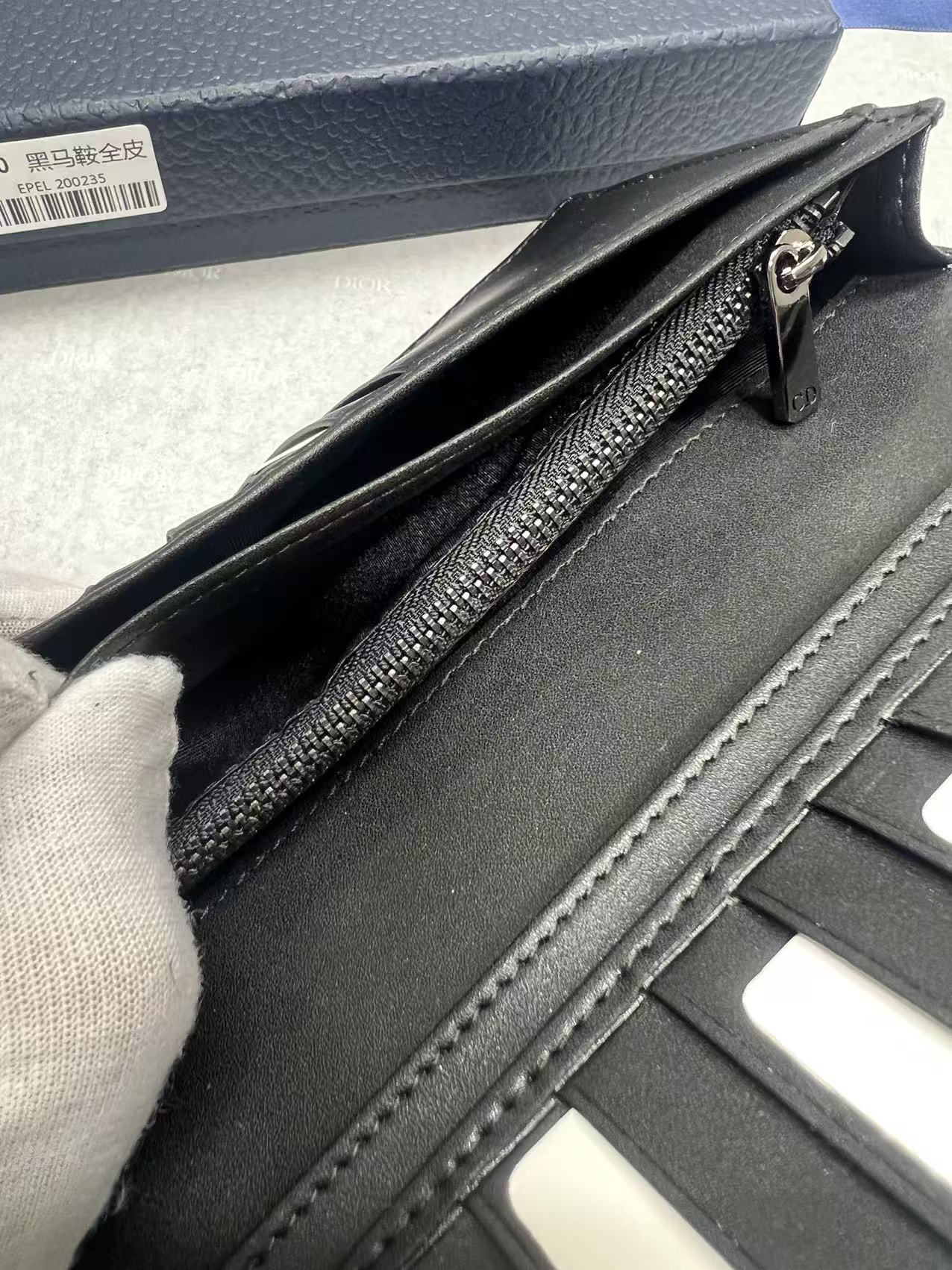 Dior small bag interior with card slots, black leather, and stitched trim