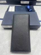 Black textured leather wallet, vertical front with embossed logo detail