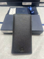 Dior small leather wallet with textured finish and embossed logo, front view