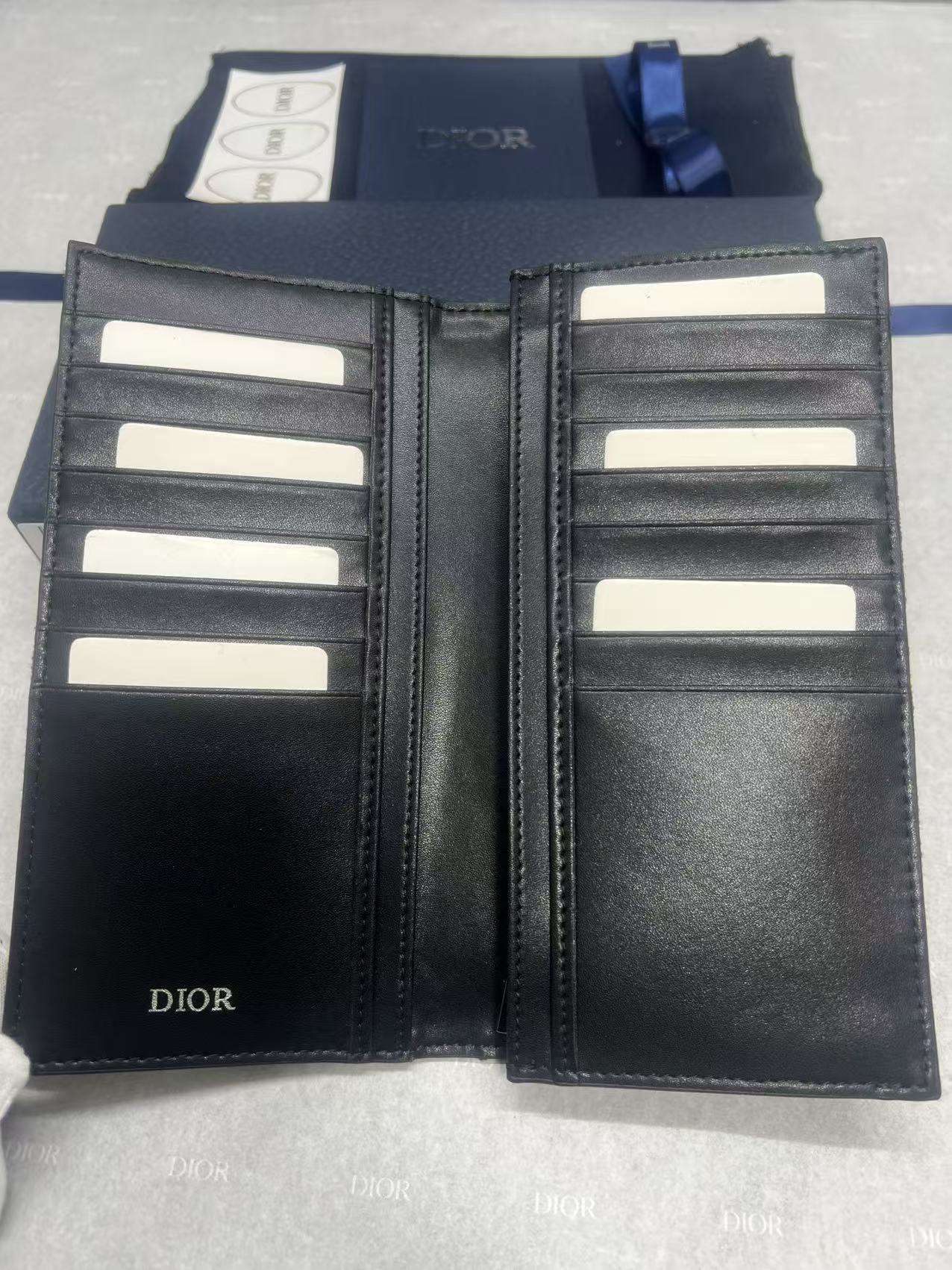 Dior small leather wallet open interior with multiple card slots and black lining
