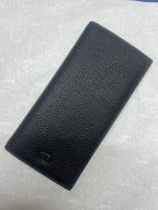 Dior small leather wallet with textured finish and embossed logo, angled view