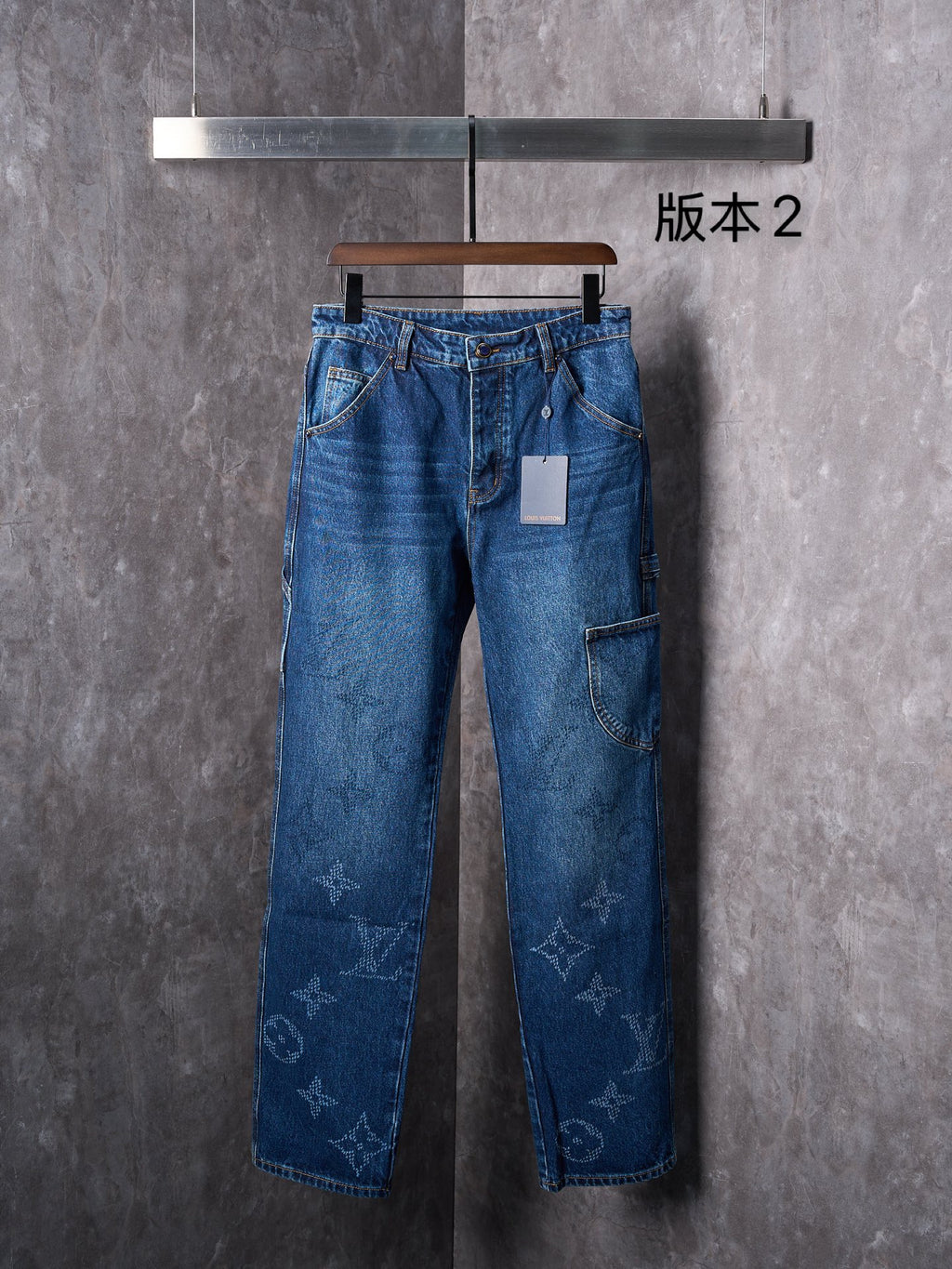 Louis Vuitton long blue denim pants with monogram-style print on legs