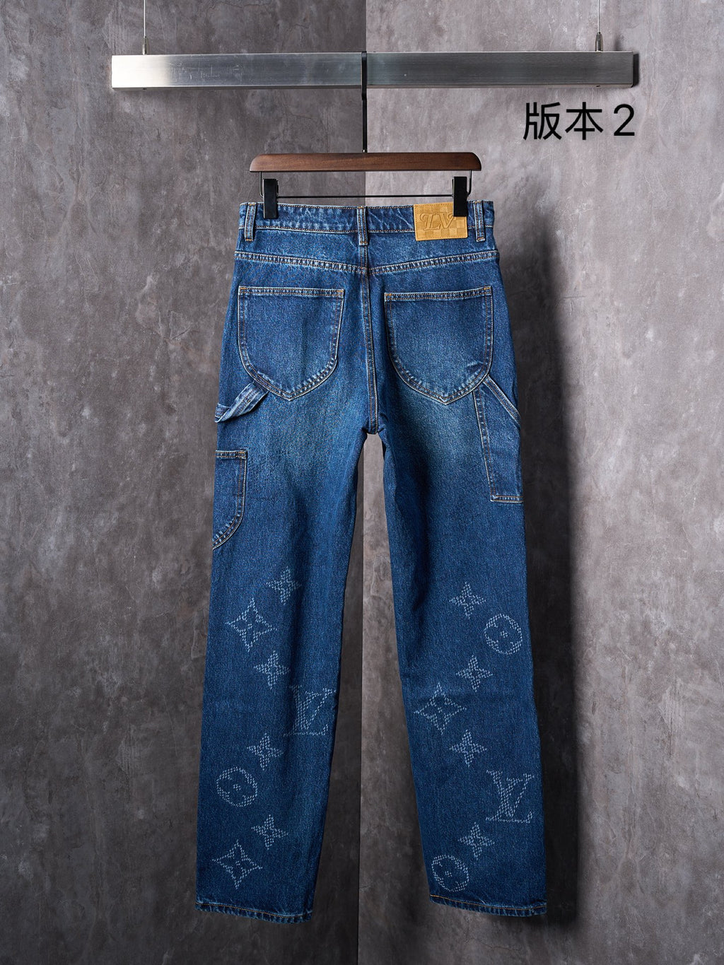 Louis Vuitton blue denim pants, front view with patch pockets and belt loops