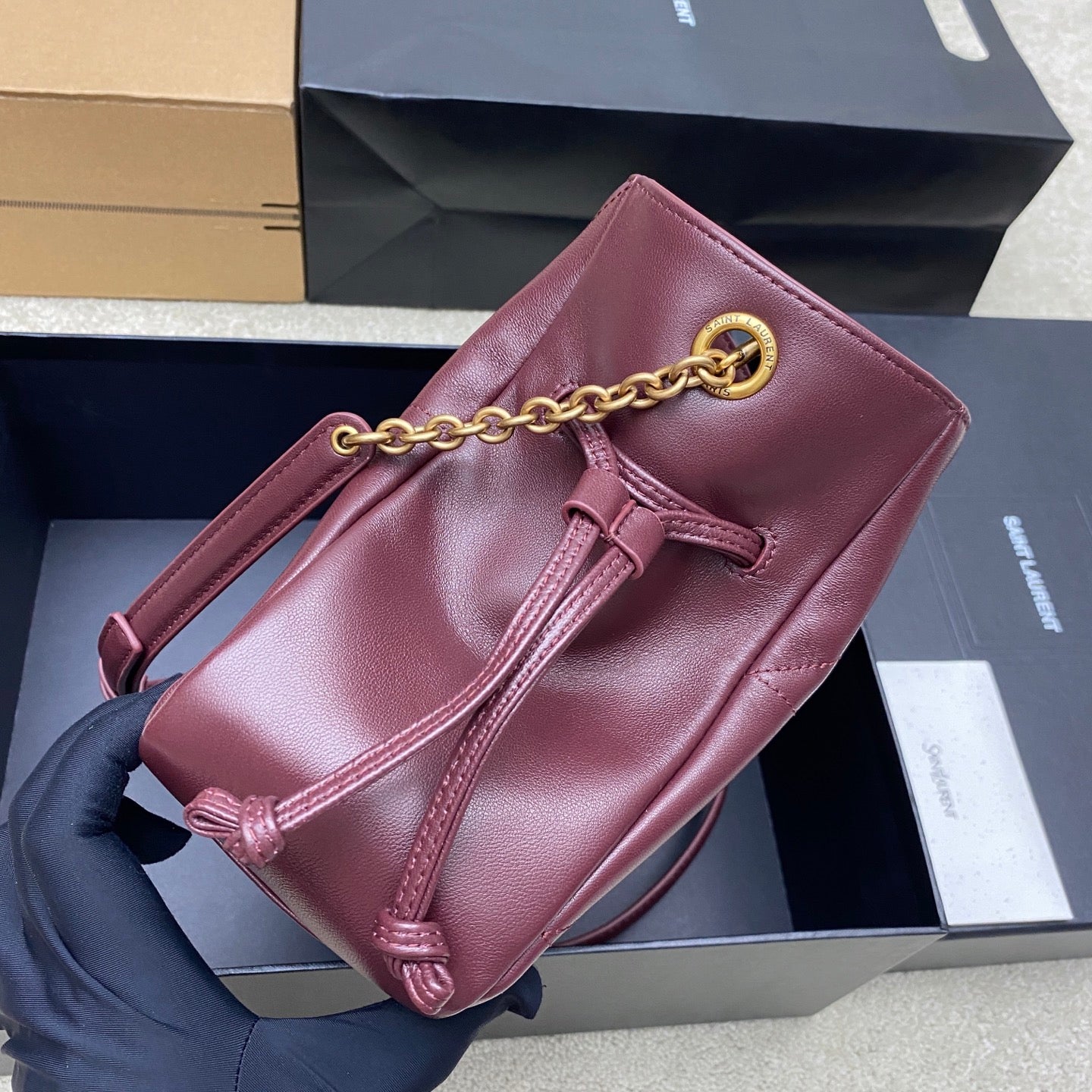 YSL pink leather bucket bag with gold chain handle and front zipper pull