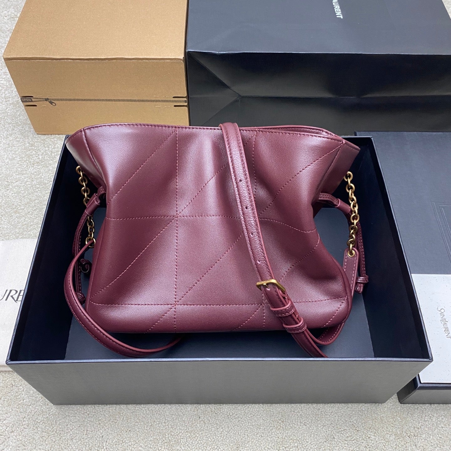 YSL pink quilted bag with chain shoulder strap and top drawstring closure