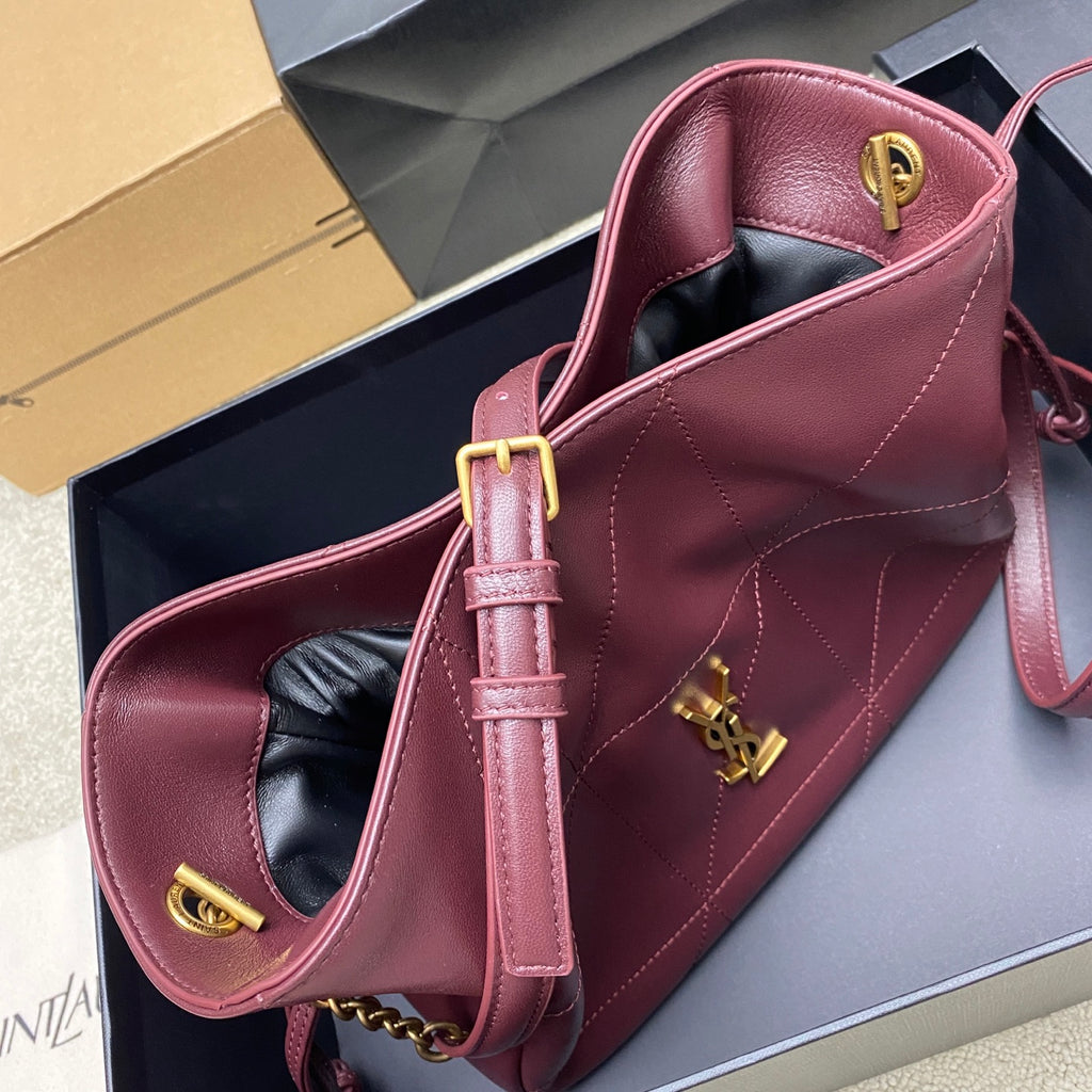 YSL pink quilted leather bag with gold hardware, top handle, and shoulder strap