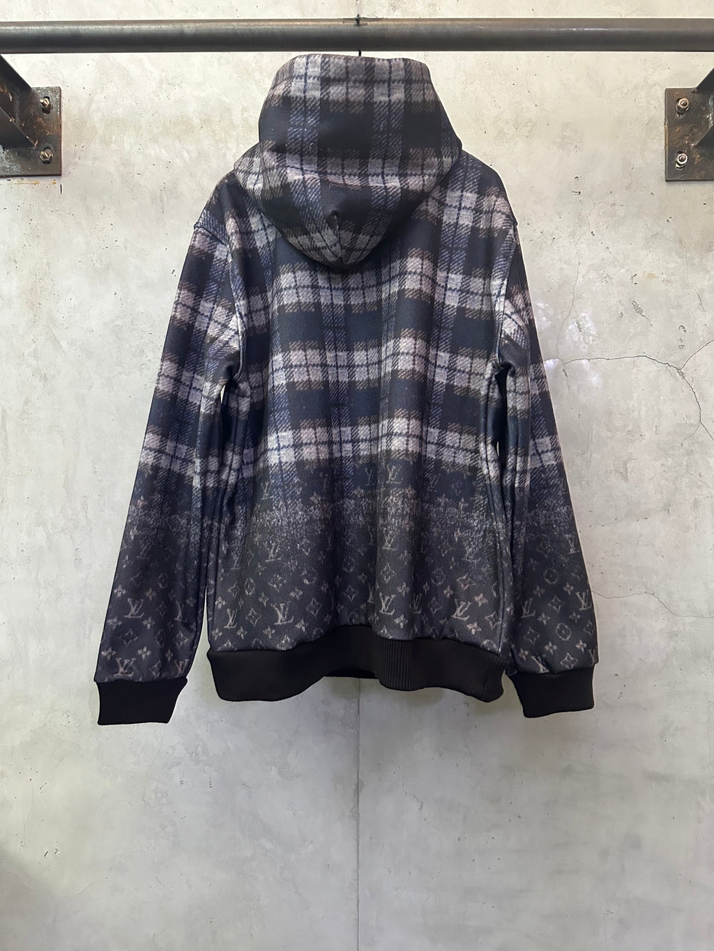 Navy plaid hoodie with attached hood and dark ribbed cuffs