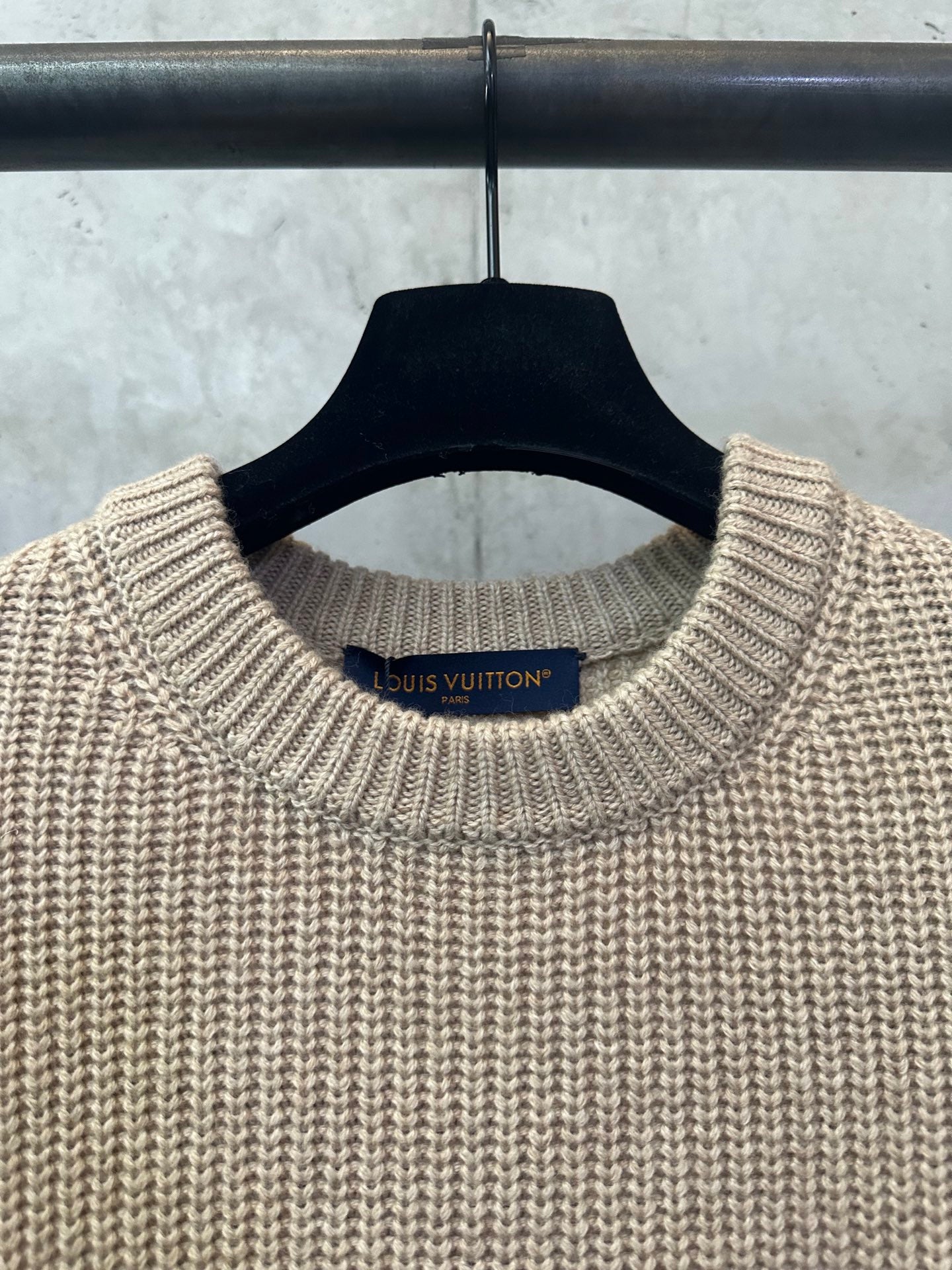 Beige knit sweater neckline with Louis Vuitton brand label