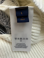 Cream knit garment care label with Louis Vuitton logo and wash symbols