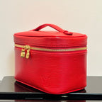 Louis Vuitton red cosmetic bag on base with gold zipper and top handle.