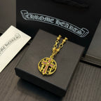 Gold-tone chain necklace with round red crest pendant on display.