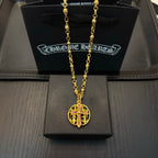 Gold-tone chain necklace with round red enamel crest pendant.