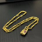 Gold-tone chain necklace set with rectangular pink gemstone pendant charms