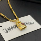 Gold-tone pendant necklace with engraved rectangular charm and pink gemstone inlay