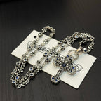 Cross pendant necklace with blue enamel and silver-tone chain on jewelry card