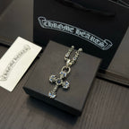 Cross pendant necklace on jewelry box, blue enamel accents, silver-tone chain