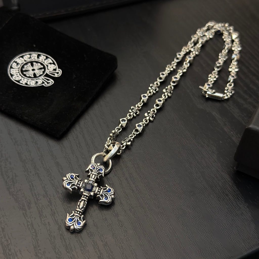 Cross pendant necklace with blue enamel, silver-tone chain and clasp detail