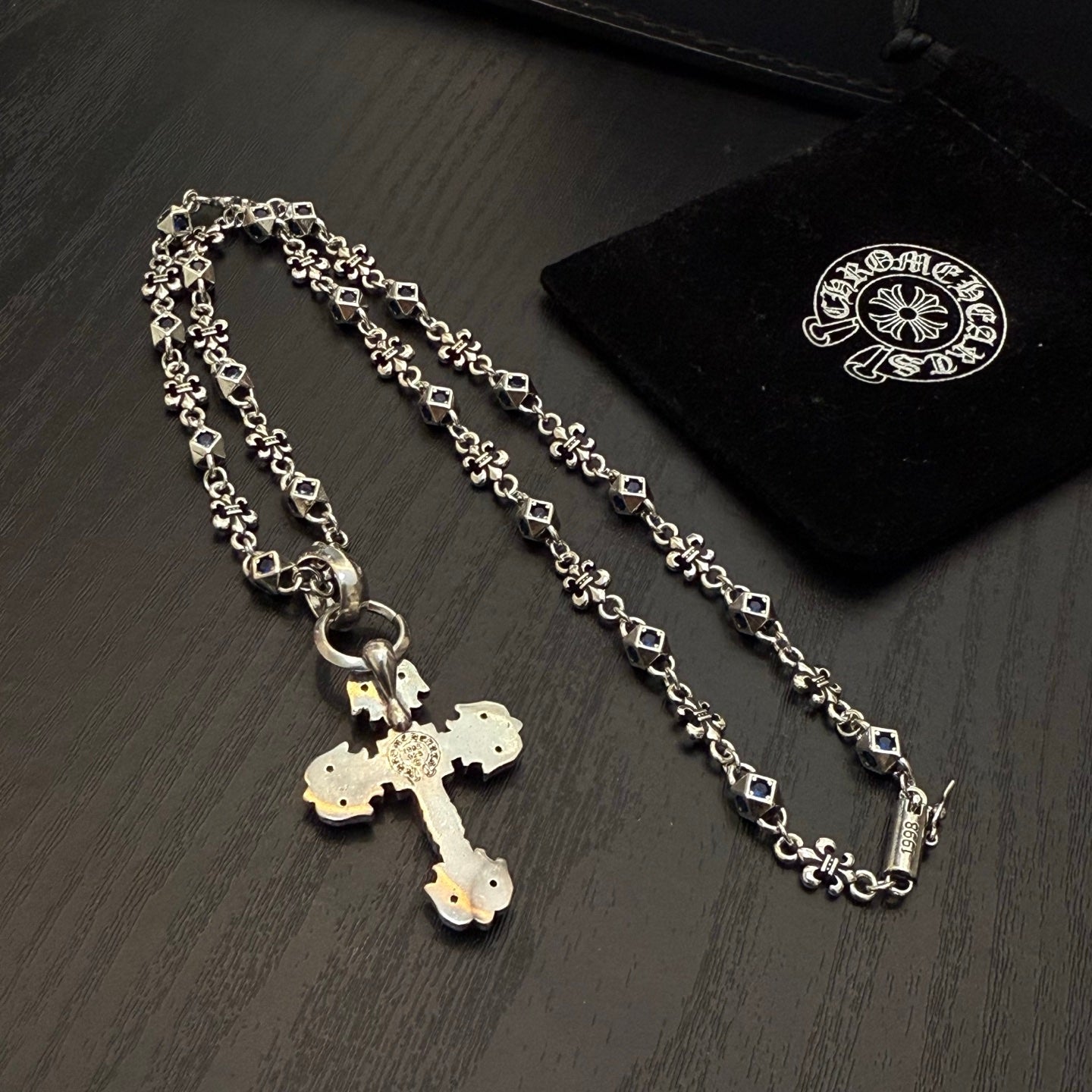Silver-tone cross pendant necklace with blue enamel and oval link chain