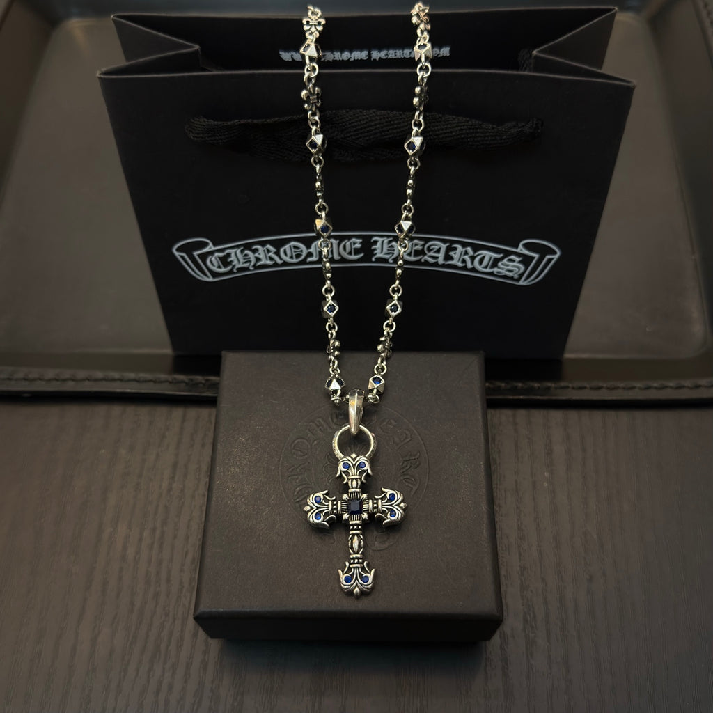Cross pendant necklace with blue enamel accents and silver-tone chain