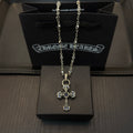 Cross pendant necklace with blue enamel accents and silver-tone chain