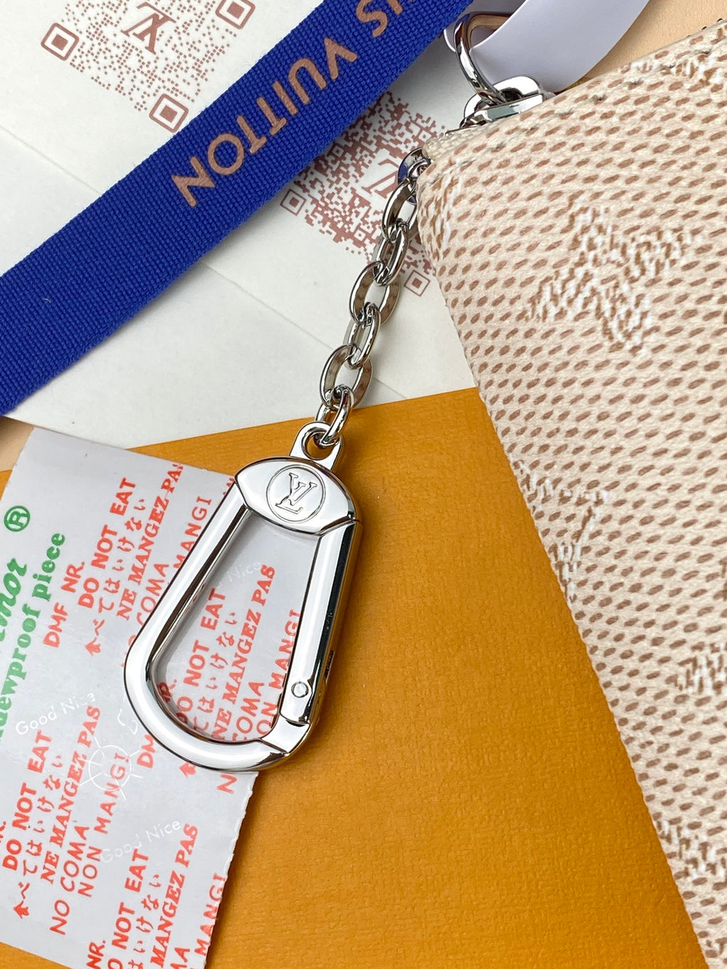 Mini crossbody bag with silver chain, monogram print, and circular LV detail