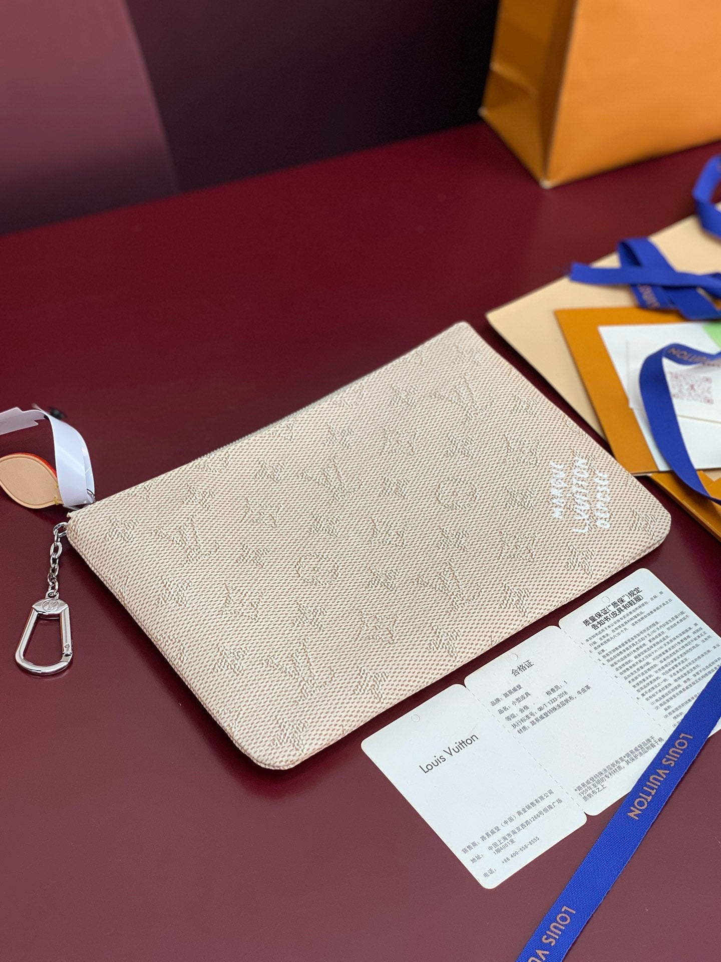 Louis Vuitton white textured clutch bag with wrist strap and paper card