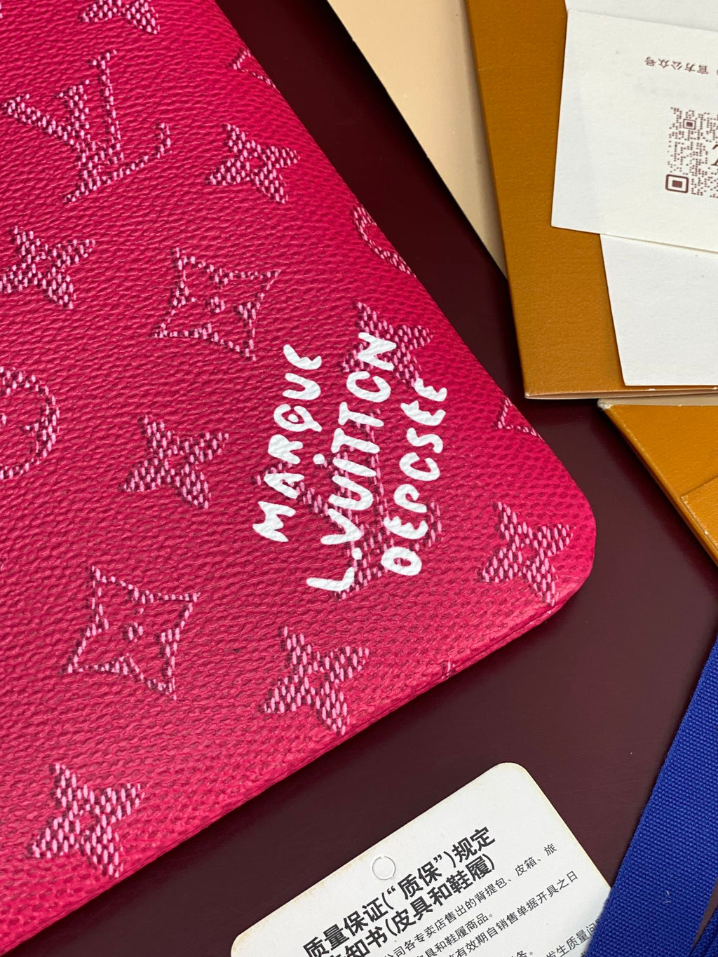 Louis Vuitton pink monogram pouch fabric close-up with LV pattern