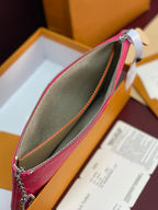 Louis Vuitton pink monogram wristlet pouch close-up with tan lining and zipper
