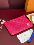 Pink Louis Vuitton wristlet pouch with monogram print and silver chain key ring