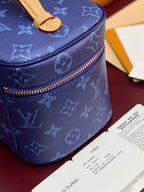 Louis Vuitton blue monogram vanity bag with brass-tone zipper and structured sides