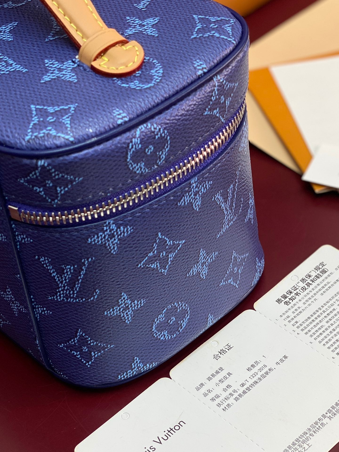 Louis Vuitton blue monogram vanity bag with brass-tone zipper and structured sides