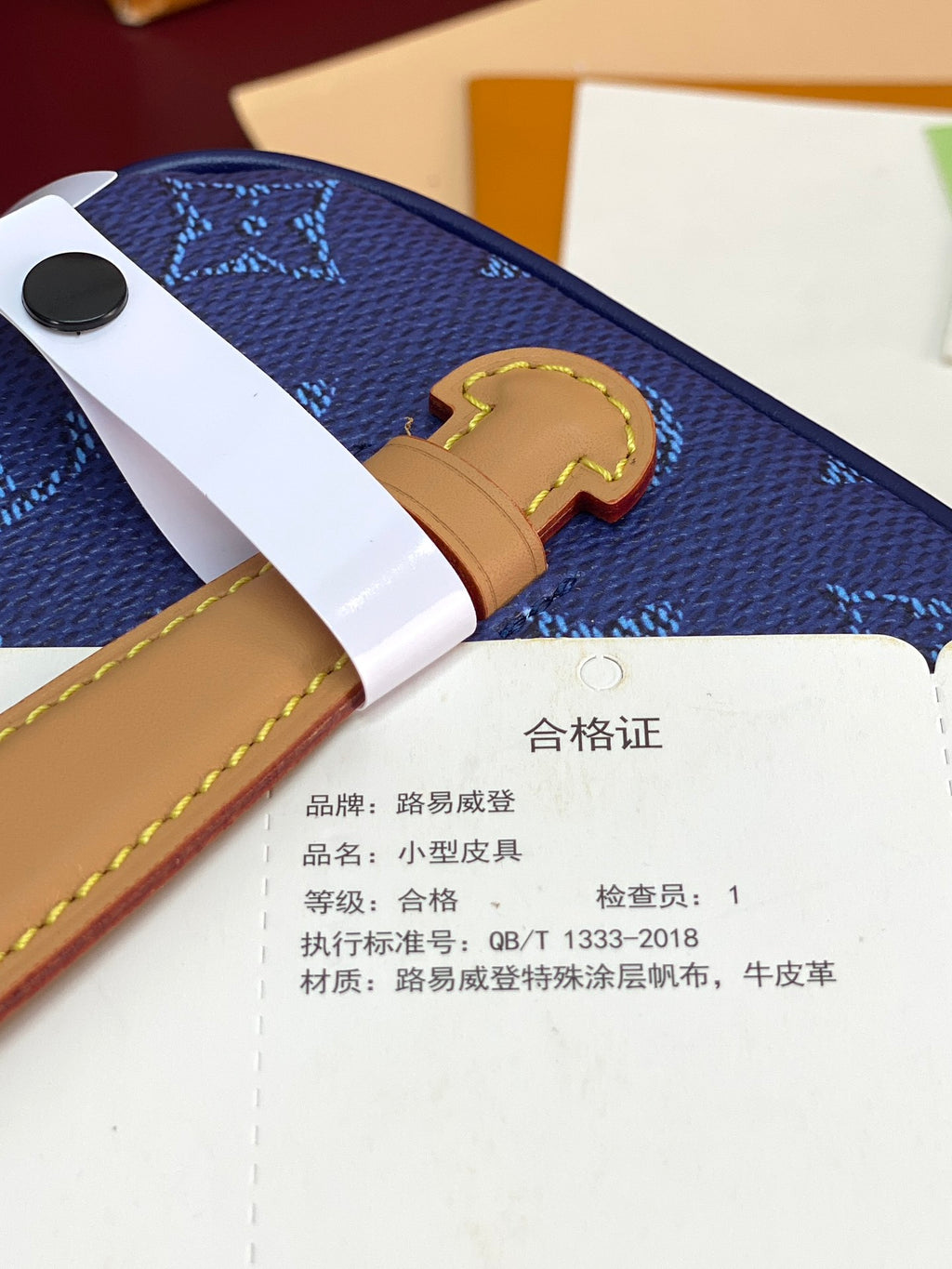 Louis Vuitton blue monogram bag with tan strap and authenticity card