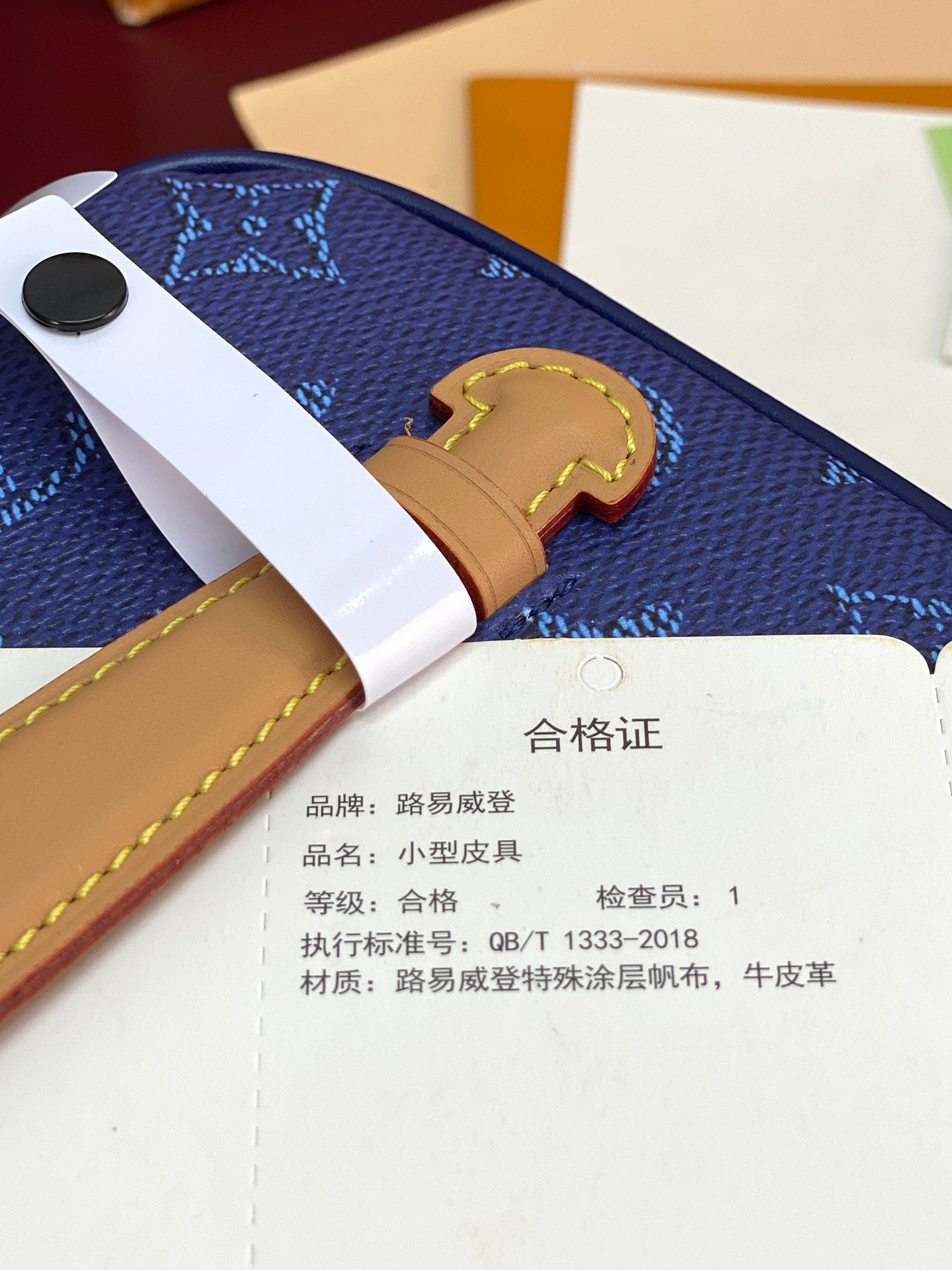 Louis Vuitton blue monogram bag with tan strap and authenticity card