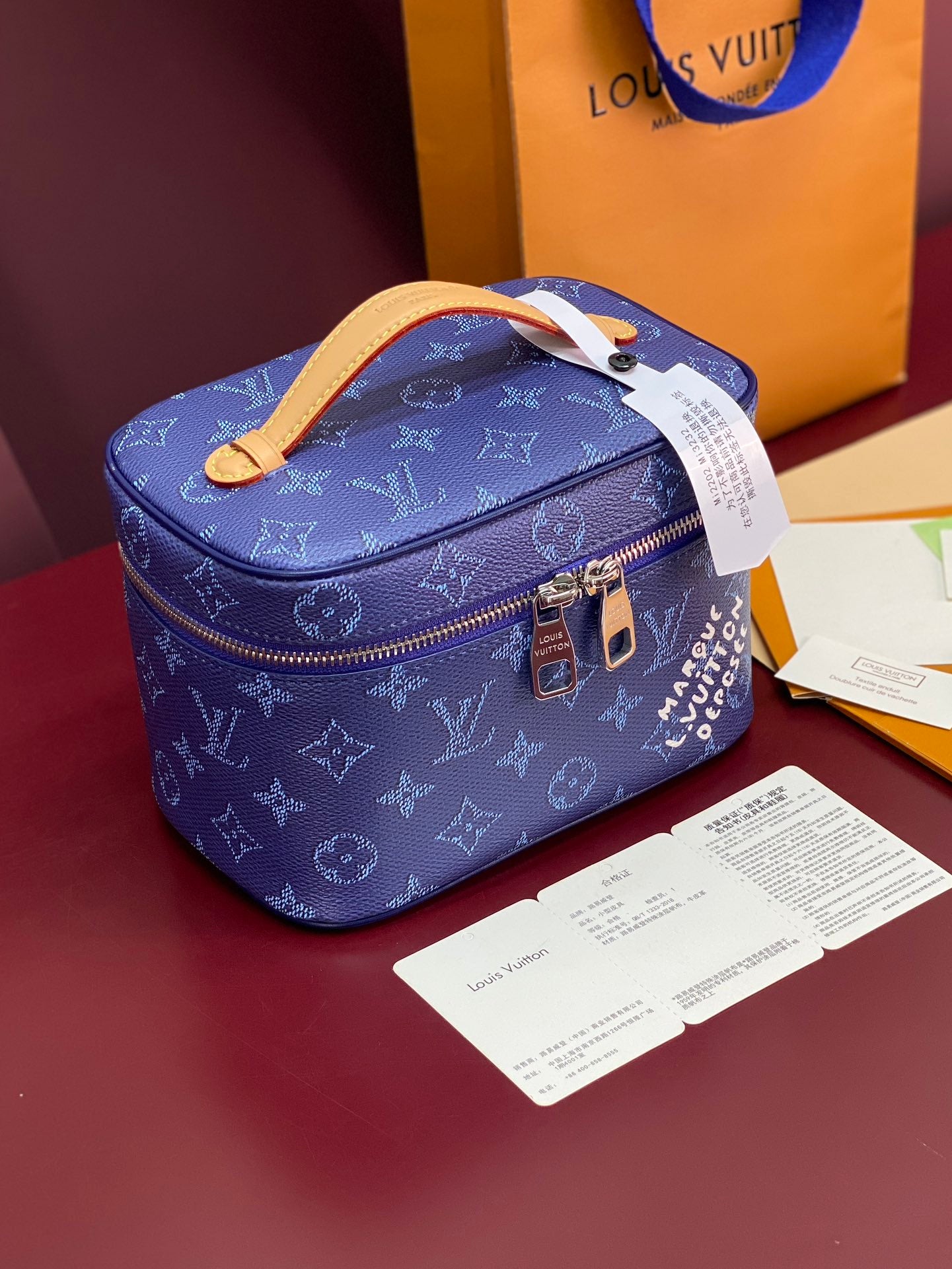 Louis Vuitton blue monogram vanity bag with tan handle and top zip closure