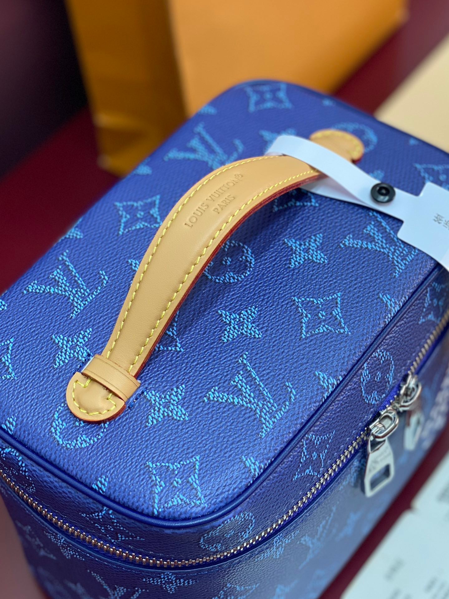 Louis Vuitton blue monogram vanity bag with tan leather strap and gold-tone hardware