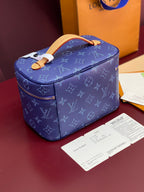 Louis Vuitton blue monogram vanity bag with tan top handle and front zipper