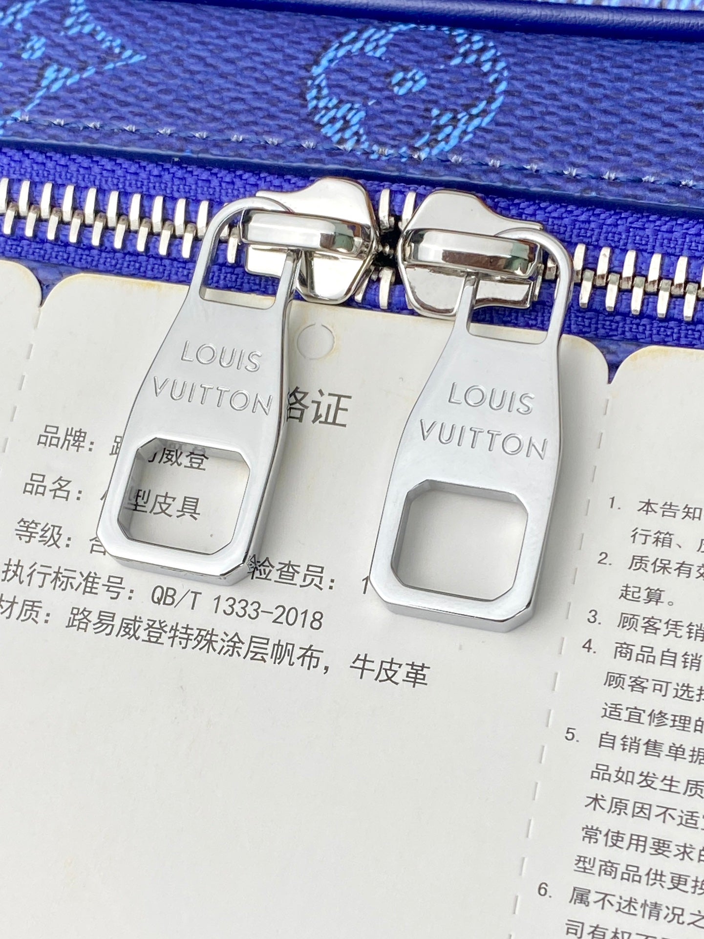 Louis Vuitton bag, white leather with blue zipper and silver clasp detail