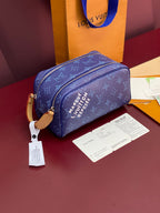 Blue monogram crossbody bag with top zip and gold-tone hardware; includes tag.