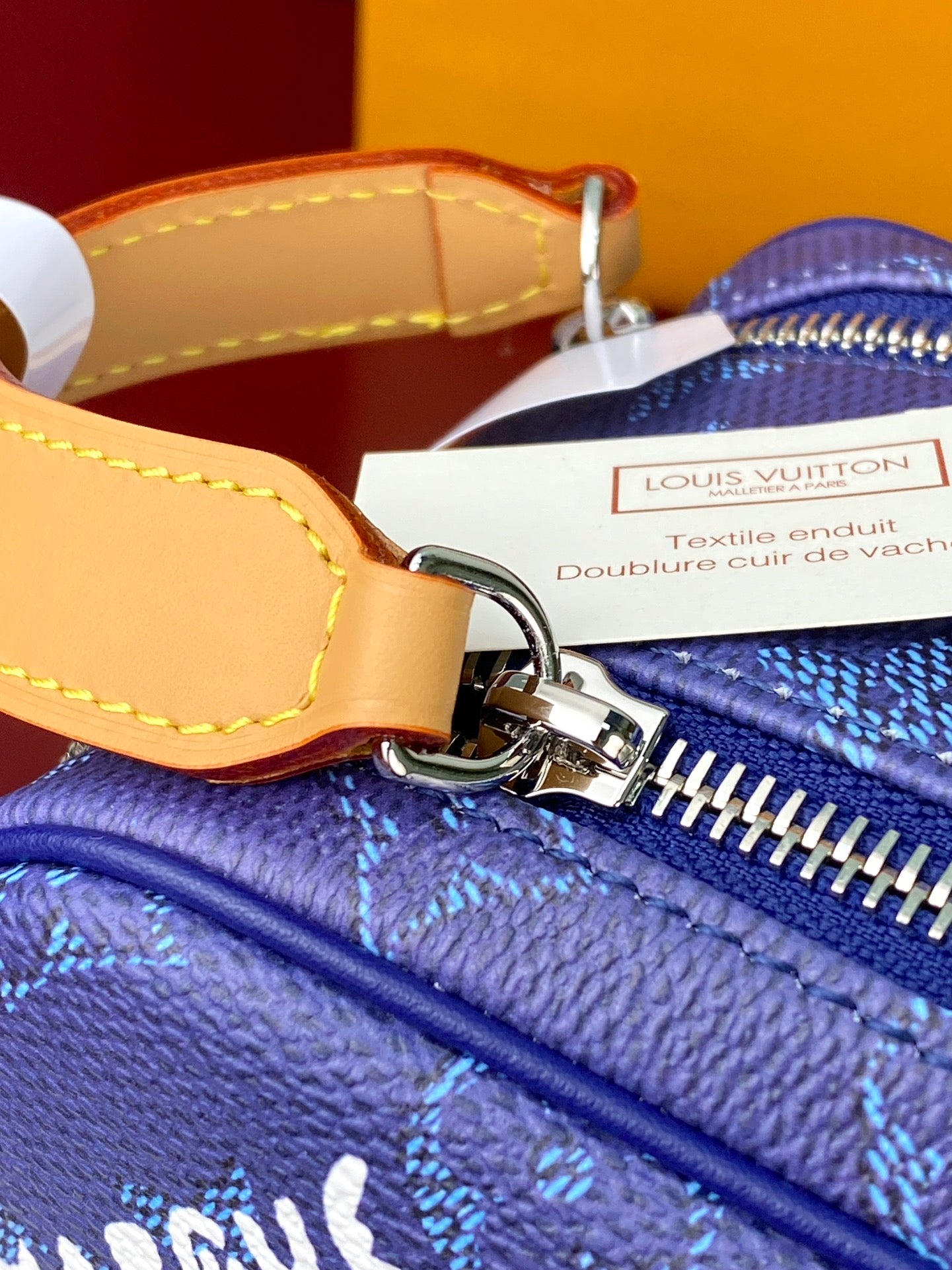 Louis Vuitton blue monogram bag detail, silver zipper pull and ring hardware