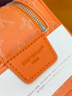 Orange monogram leather zip bag with LV logo and corner zipper pull