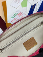 White leather interior with Louis Vuitton logo patch and pink-trim zipper