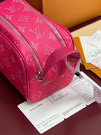 Pink monogram toiletry bag side view with top handle and silver zipper