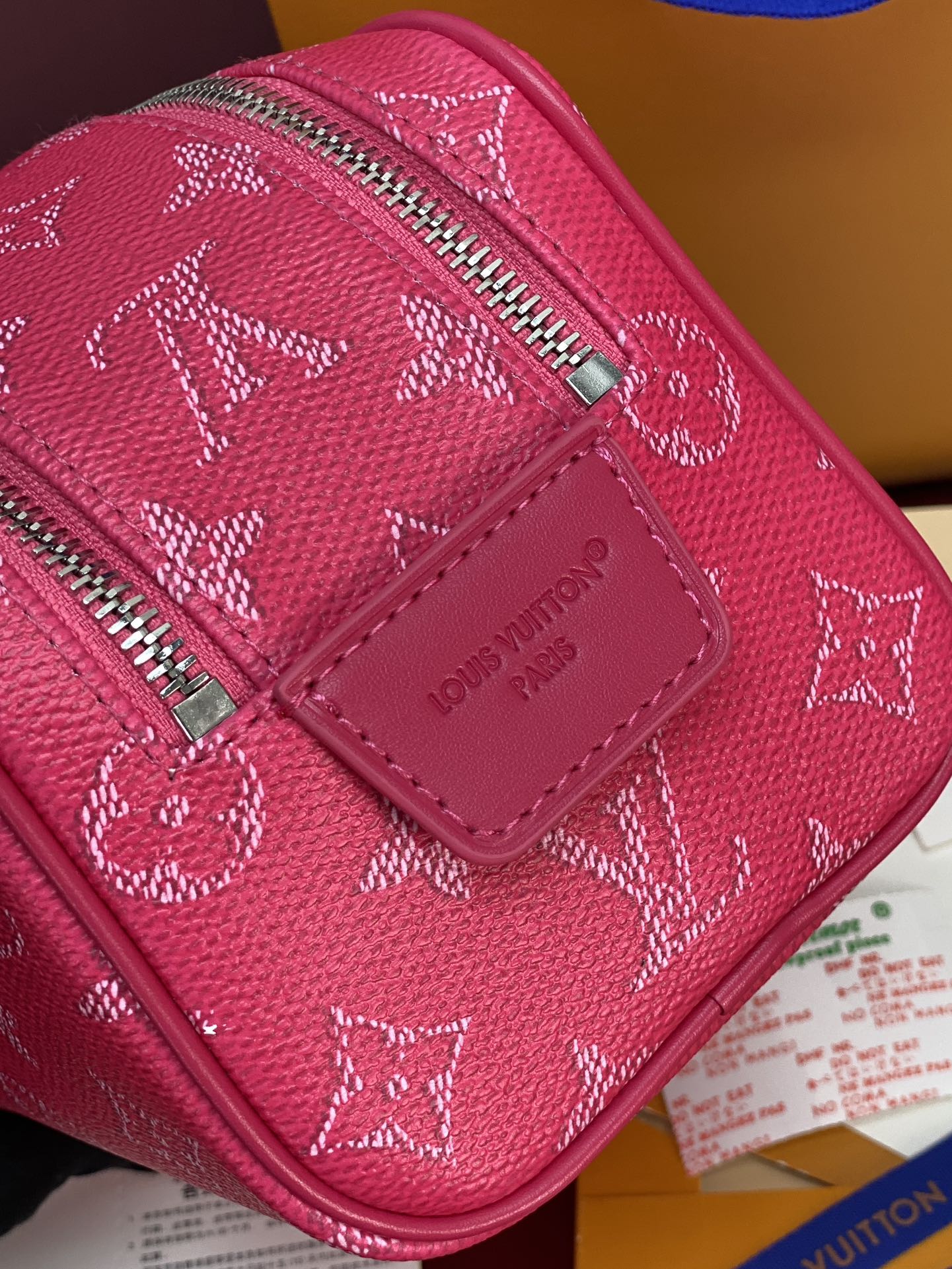 Pink monogram canvas bag with Louis Vuitton logo patch and zip closure