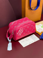 Pink monogram toiletry bag with top zip and detachable leather strap